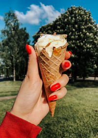 Cropped hand of person holding ice cream cone