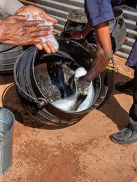 Midsection of man working at fish