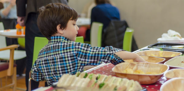 Boy having food at restaurant