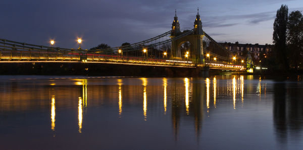 View of bridge over river at night