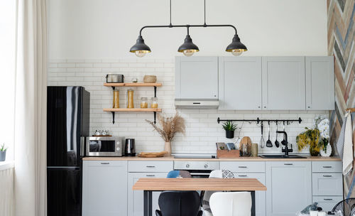 Interior of kitchen in rustic style with vintage kitchen ware and wooden wall