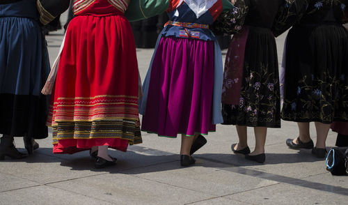 Low section of women standing on street