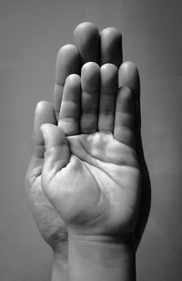 Close-up of hand holding over white background