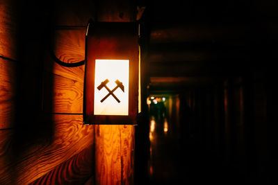 Illuminated sign on wall at night