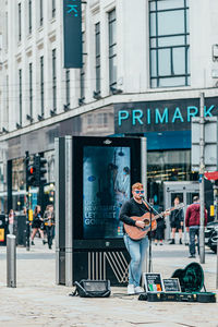 Man standing on street in city