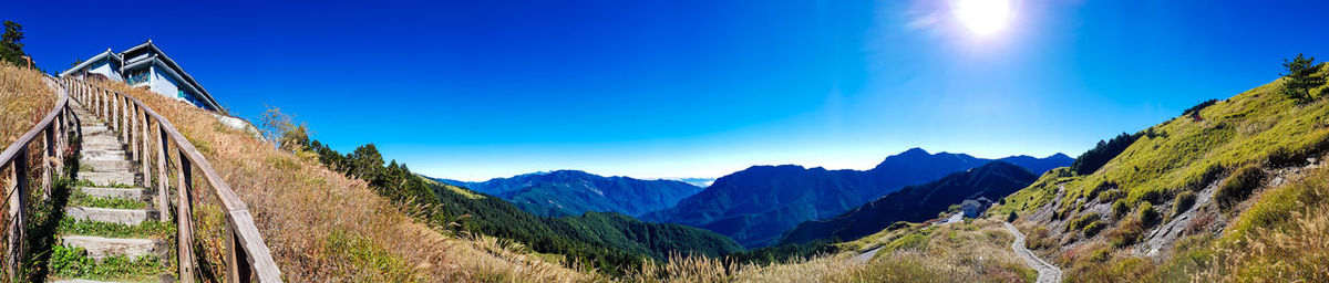 Panoramic view of mountains against blue sky