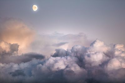 Low angle view of moon in sky during sunset