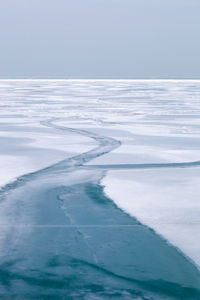 Scenic view of sea against sky during winter