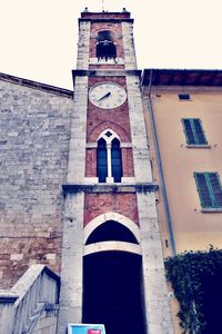 Low angle view of bell tower against sky