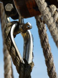 Low angle view of chain hanging against sky