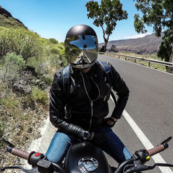 Man riding motorcycle on road