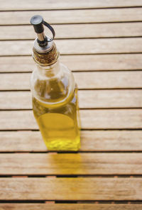 Oil in bottle on wooden table