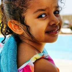 Portrait of smiling girl at poolside