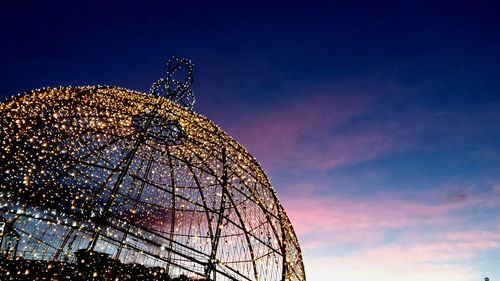 Low angle view of ferris wheel against sky at night