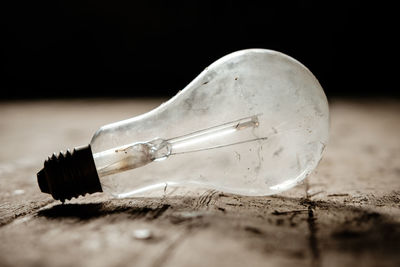 Close-up of light bulb on table