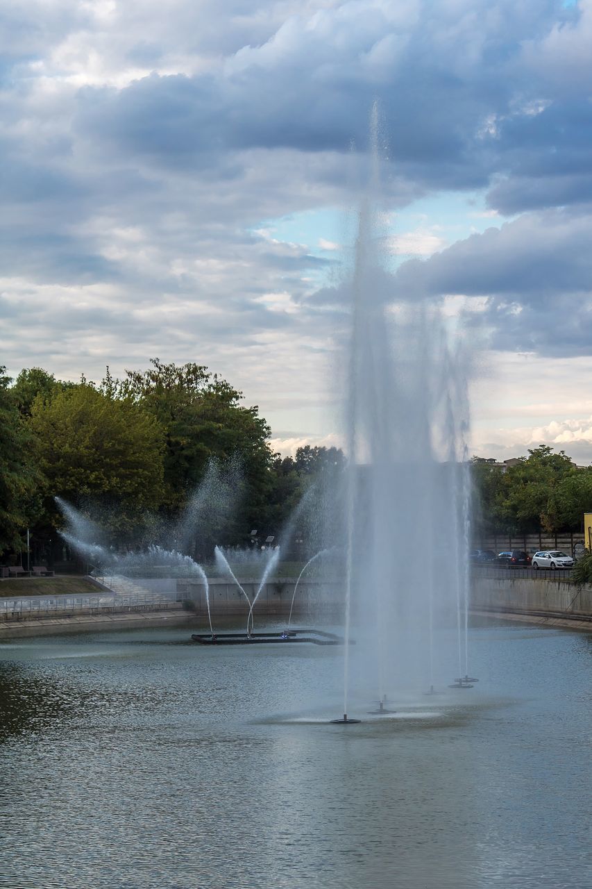 FOUNTAIN IN FRONT OF WATERFALL