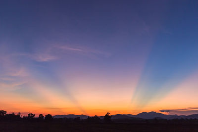 Sun rays over mountain in the evening