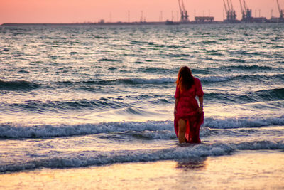 Rear view of woman looking at sea shore