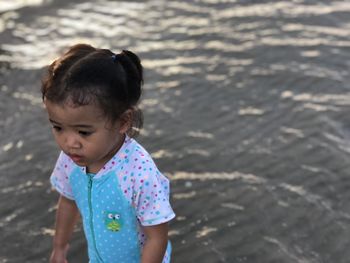 High angle view of girl standing at beach