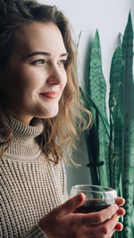 Close-up of young woman holding drink