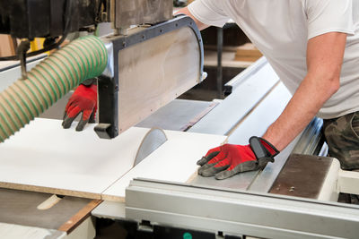 Midsection of carpenter working on table