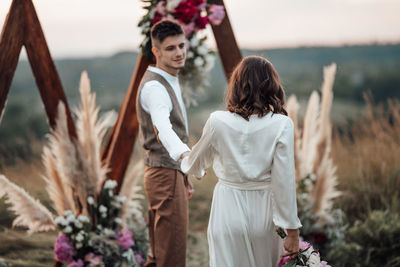 Friends standing with flowers