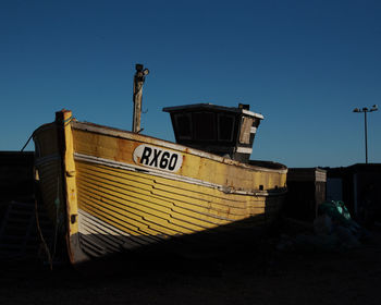 Information sign against clear blue sky