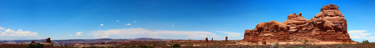 Panoramic view of rock formation against blue sky