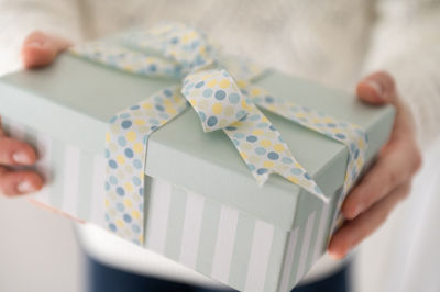 Close-up of woman holding paper in box