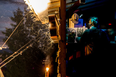 People at illuminated railroad station at night