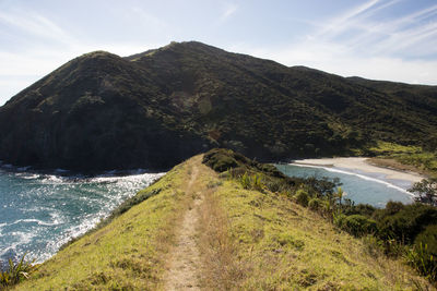 Scenic view of sea and mountains against sky