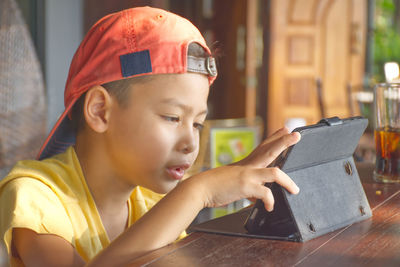 Boy using digital tablet at home