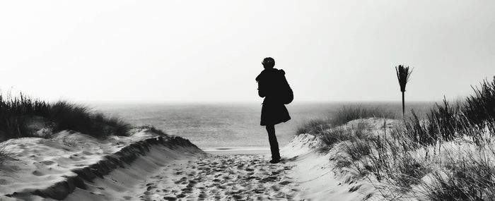 Silhouette of woman against clear sky