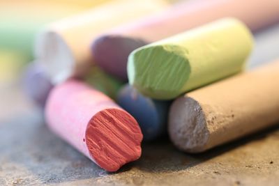 Close-up of multi colored chalks on table