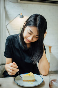 Midsection of woman holding ice cream in plate