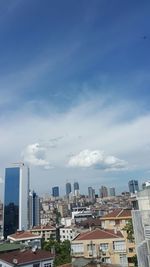 Buildings against cloudy sky