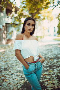 Portrait of fashionable young woman standing in park during autumn