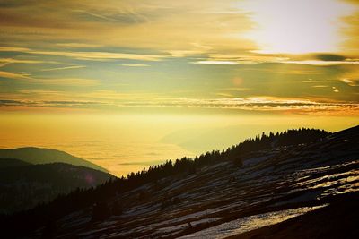 Scenic view of dramatic sky over landscape during sunset