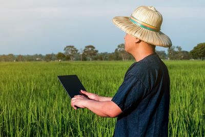 Man using mobile phone on field