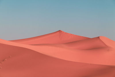 Low angle view of desert against clear sky