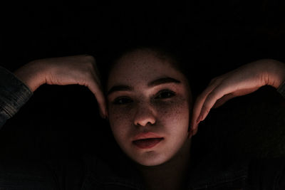 Portrait of woman over black background