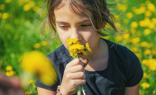 Girl smelling flowers in garden