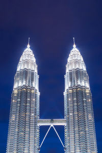 Low angle view of modern buildings against sky at night