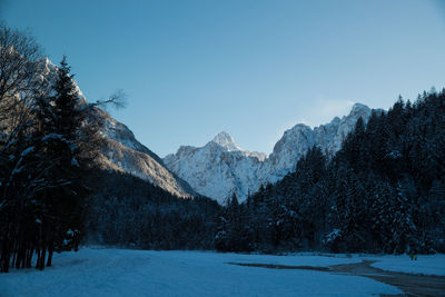 Scenic view of snowcapped mountains against clear sky