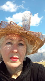 Portrait of beautiful woman against sky