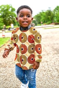 Portrait of boy standing on road