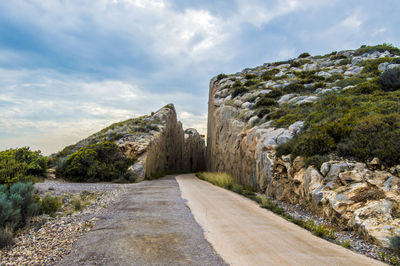 View of stone wall against cloudy sky