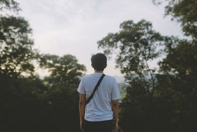 Rear view of man standing against sky