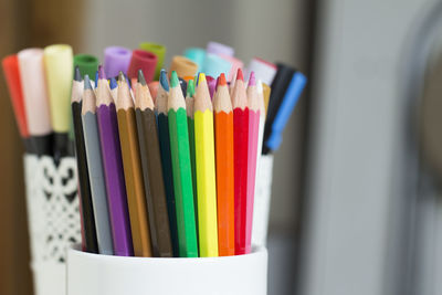 Close-up of colored pencils in desk organizer