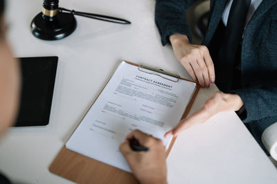 Midsection of business colleagues working on table